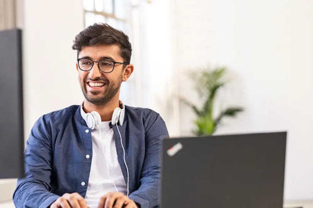 An Henkel employee working at his desk.